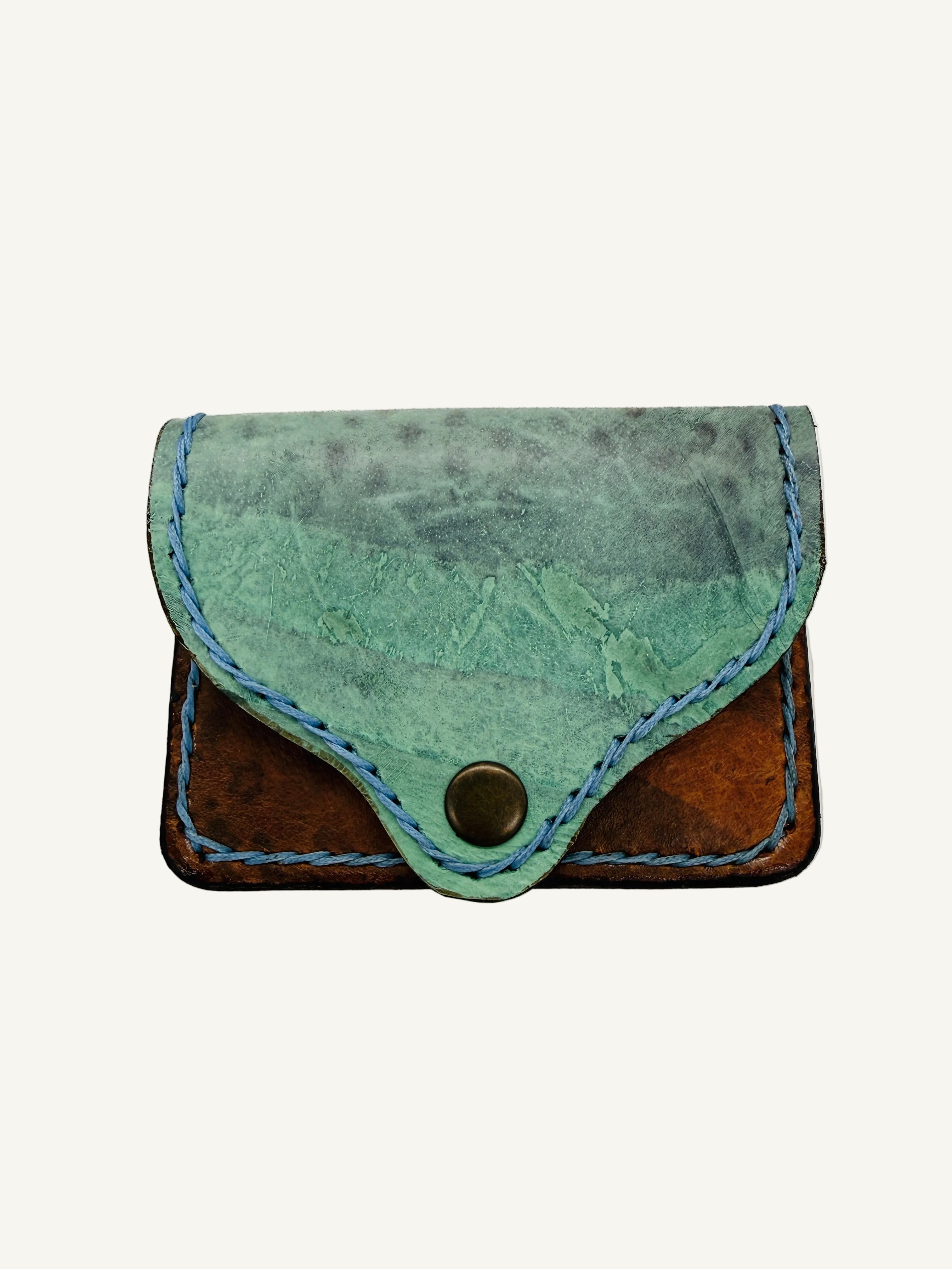 Two-tone leather wallet with green front and brown back on a white background