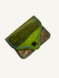 Green and brown pufferfish leather wallet with button closure on a white background
